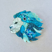 Load image into Gallery viewer, Decorative brooch with a lion design in blue and white on a light gray background
