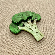 Load image into Gallery viewer, Green broccoli-shaped brooch on a beige fabric background