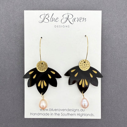 Black and gold earrings on a Blue Raven Designs card with a gray background