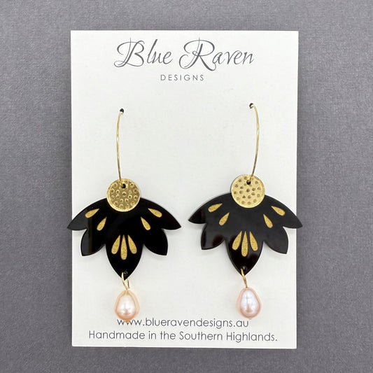 Black and gold earrings on a Blue Raven Designs card with a gray background