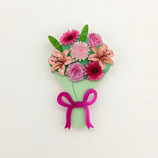 Floral bouquet with pink flowers and a green wrap on a white background
