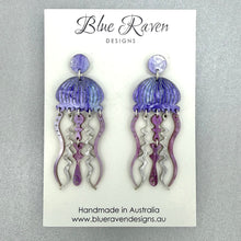 Load image into Gallery viewer, Jellyfish-shaped earrings on a Blue Raven Designs card with a gray background
