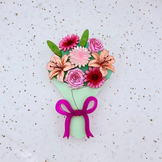 Bouquet of colorful flowers with a pink bow on a light background