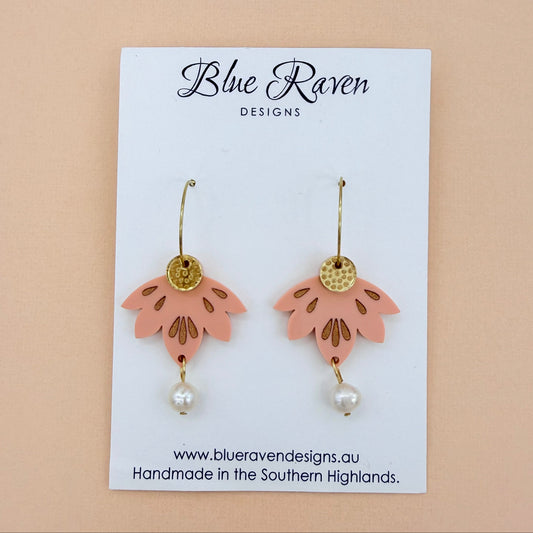 Pair of pink floral earrings with gold accents and pearl beads on a Blue Raven Designs card.