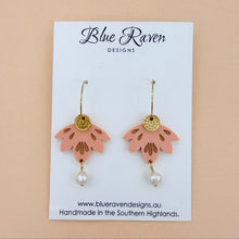Load image into Gallery viewer, Pair of pink floral earrings with gold accents and pearl beads on a Blue Raven Designs card.
