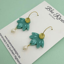 Load image into Gallery viewer, Green leaf-shaped earrings with pearl details on a Blue River Designs card.
