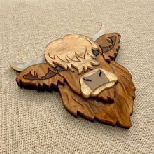 Load image into Gallery viewer, Highland cow head acrylic brooch on a textured beige background

